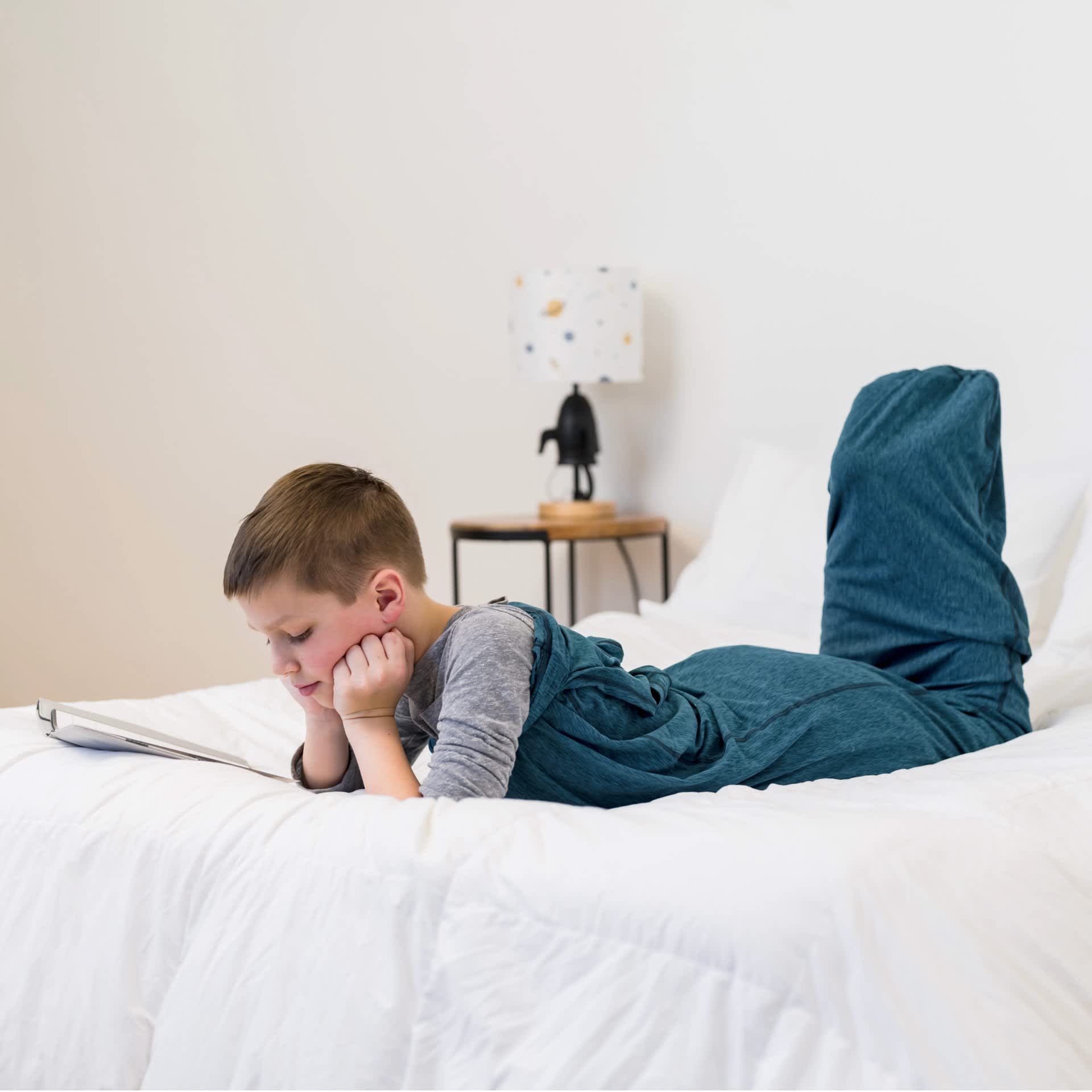 child in sleep pod reading