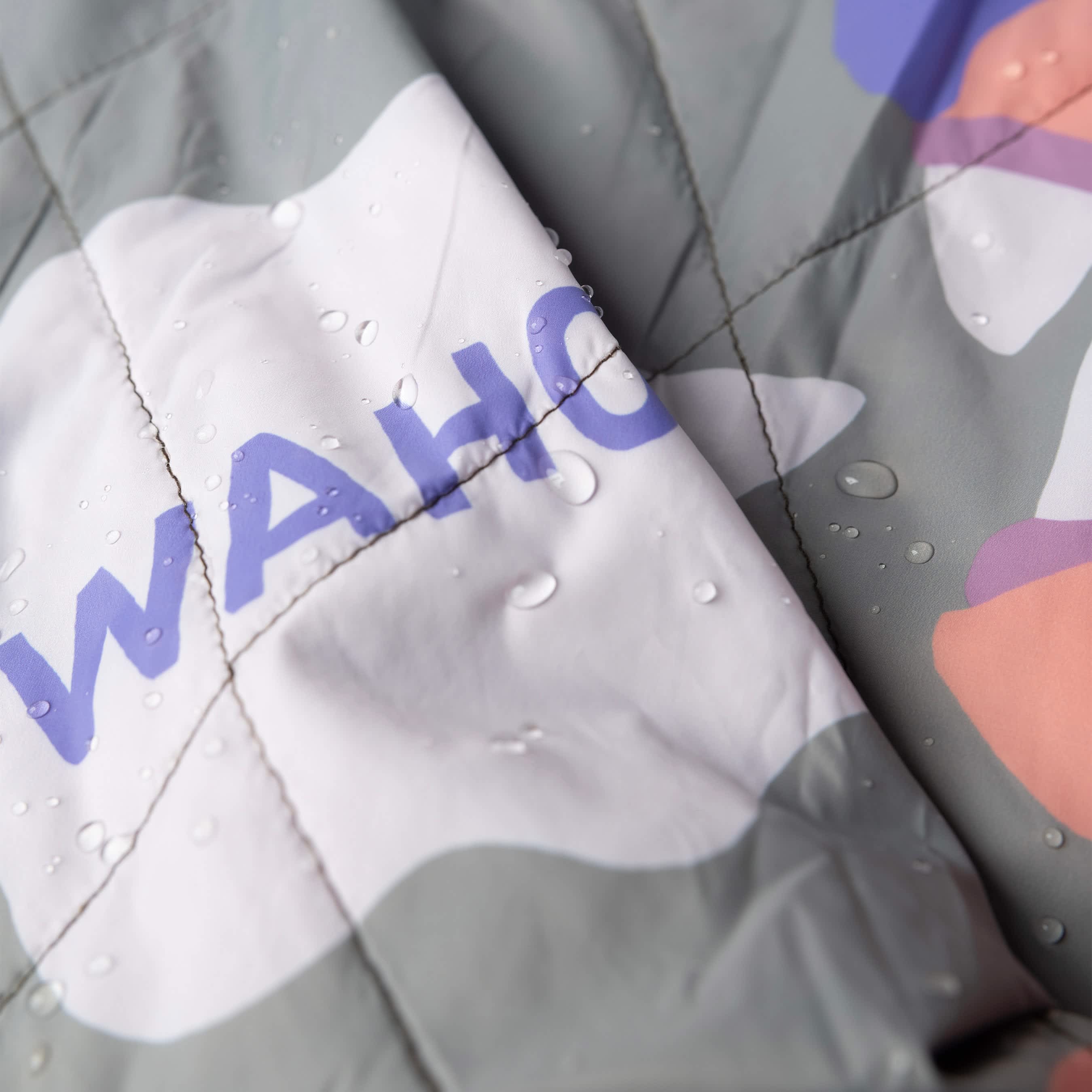 Packable blanket with dog and 'WAHOO' text, close-up view.