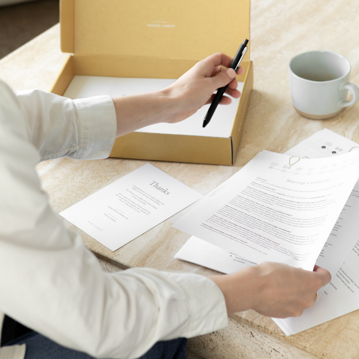 Woman holding pen with name change forms