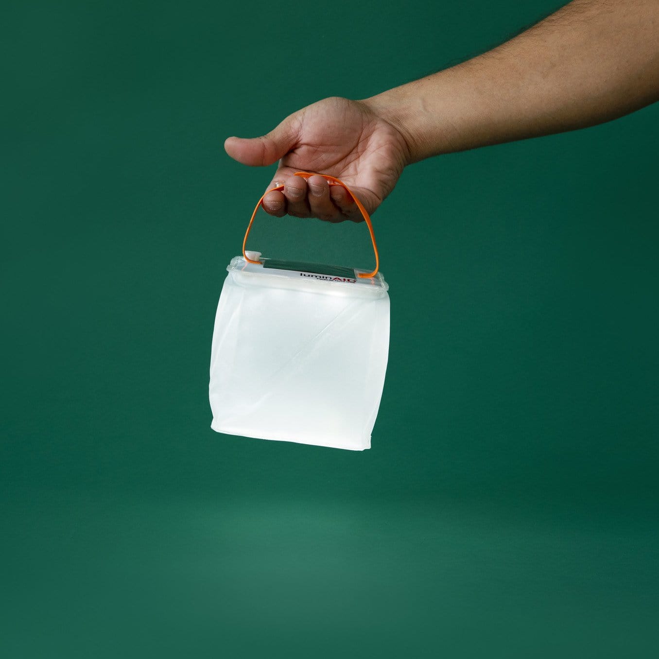 Holding a lantern with the adjustable strap.