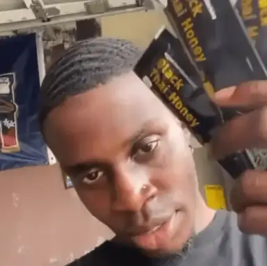Verified customer holding Black Thai Honey packs