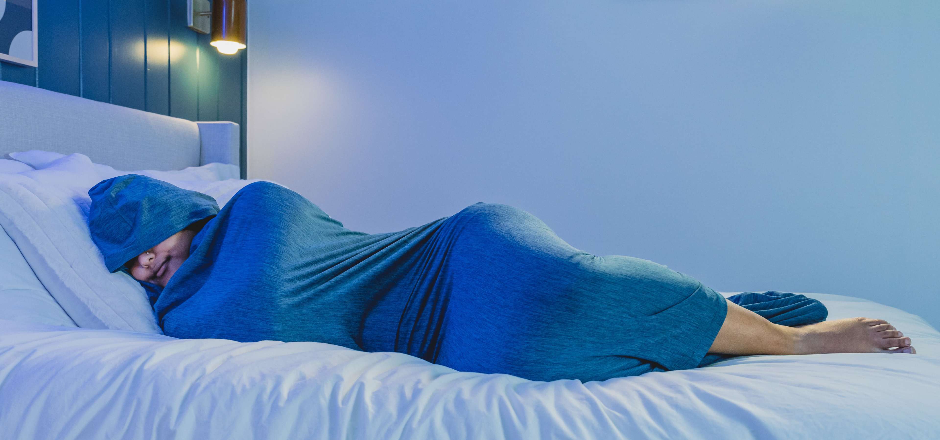 Woman in Sleep Pod laying on bed