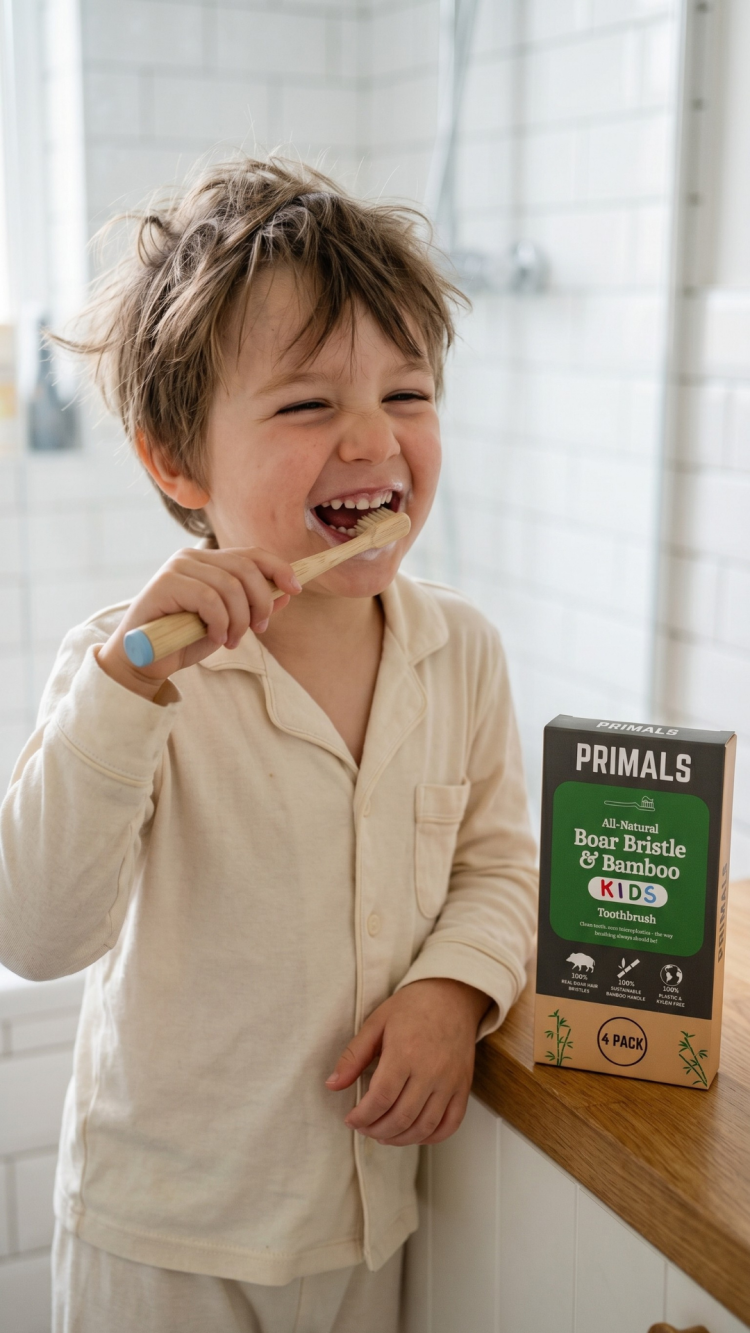 Kid happily using the PRIMALS Kids Boar Bristle Toothbrush