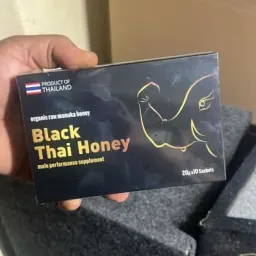 Verified customer holding a Black Thai Honey box