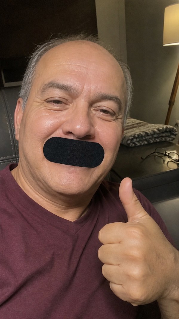 Eddie, age 56, wearing a black mouth strip