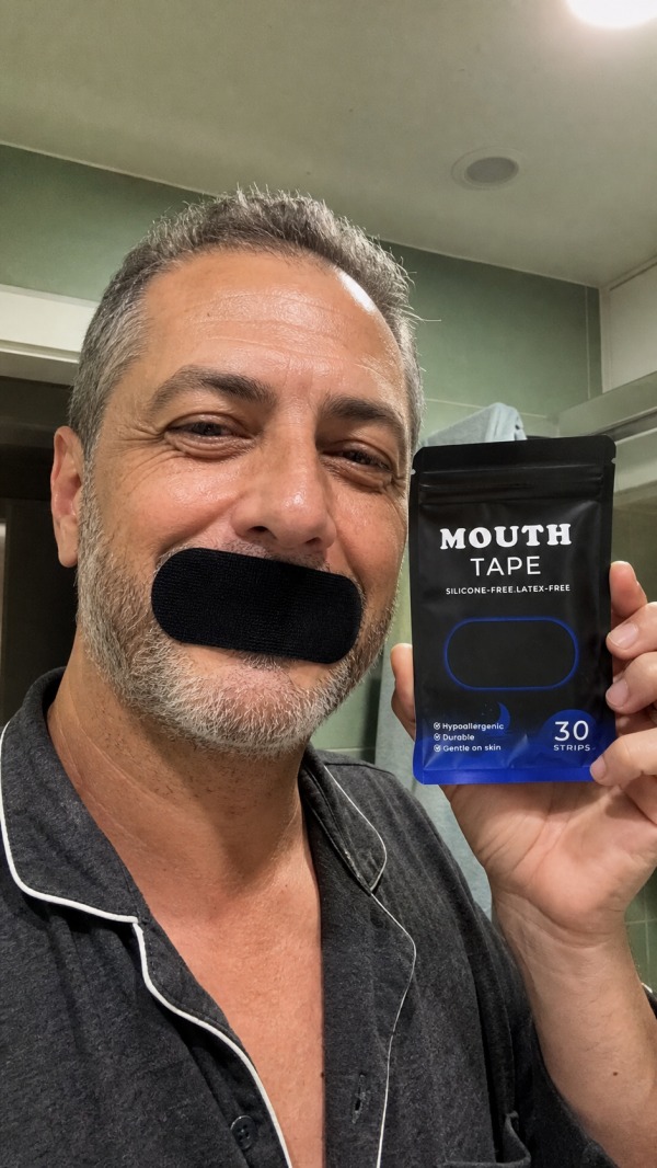 Miguel, age 49, wearing a black mouth strip