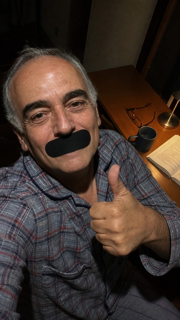 Manuel, age 58, wearing a black mouth strip
