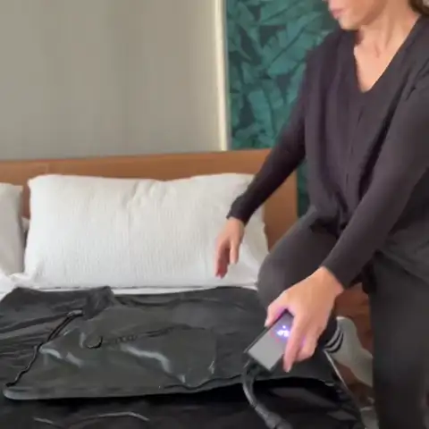 Woman zipping into the FlexiHeat sauna blanket